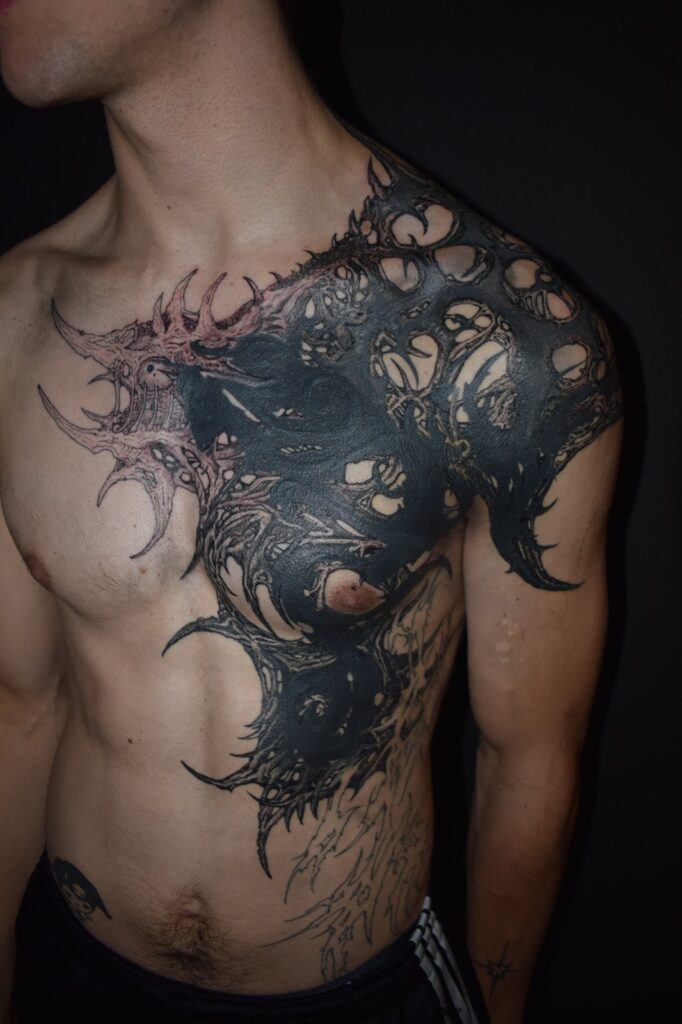 Large-scale blackwork chest and shoulder